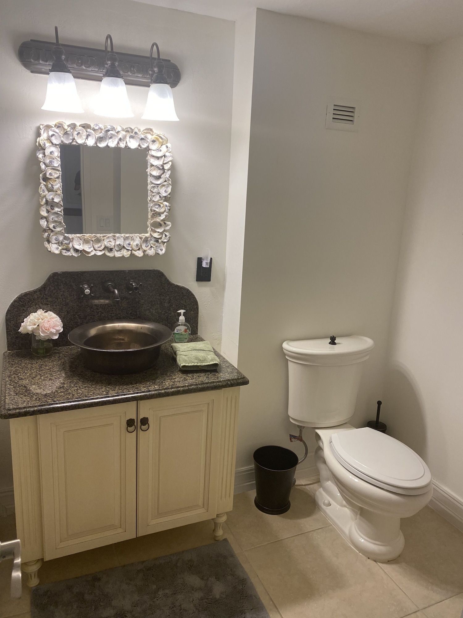 A bathroom with a sink , toilet and mirror