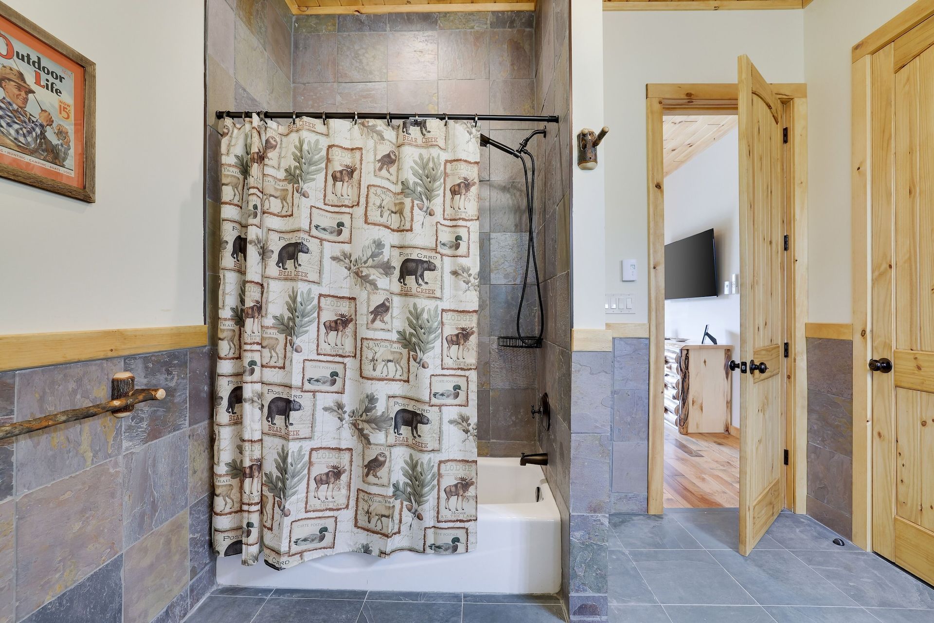 A bathroom with a shower curtain and a bathtub.