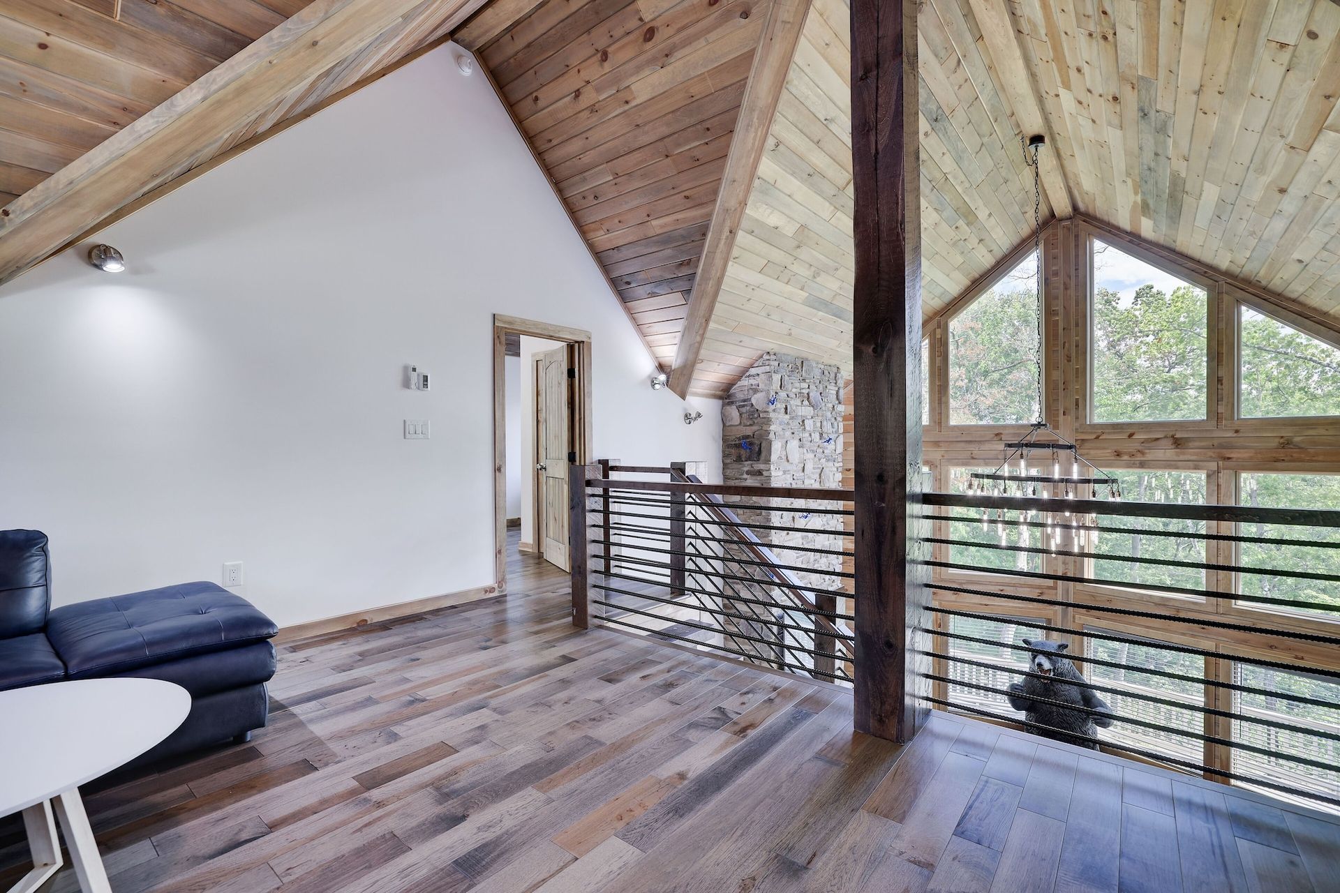 A living room with hardwood floors and a wooden ceiling.