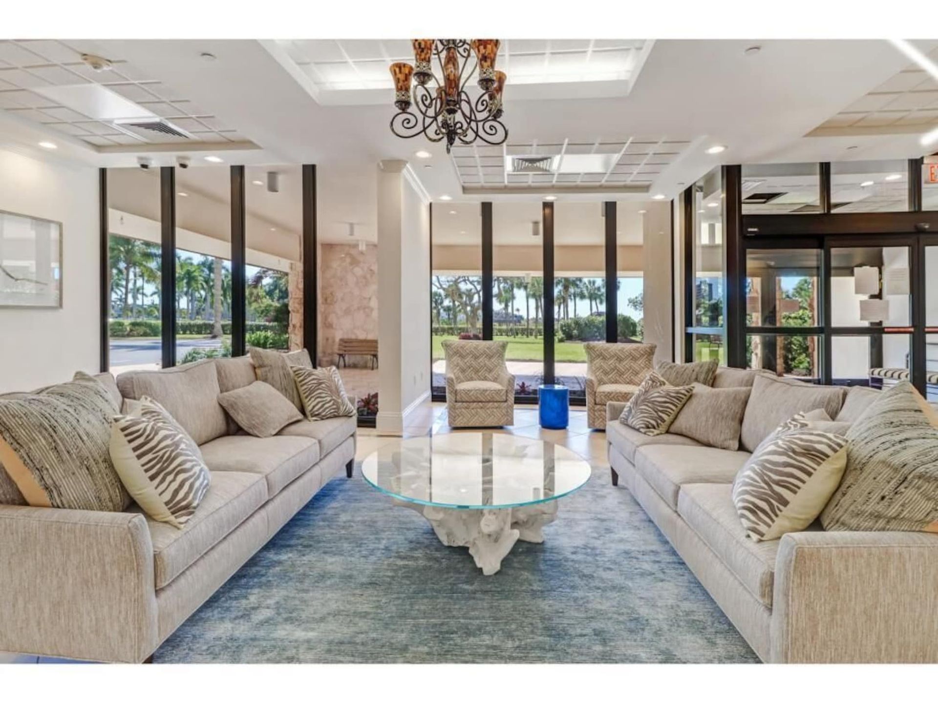 A living room with a lot of furniture and a chandelier
