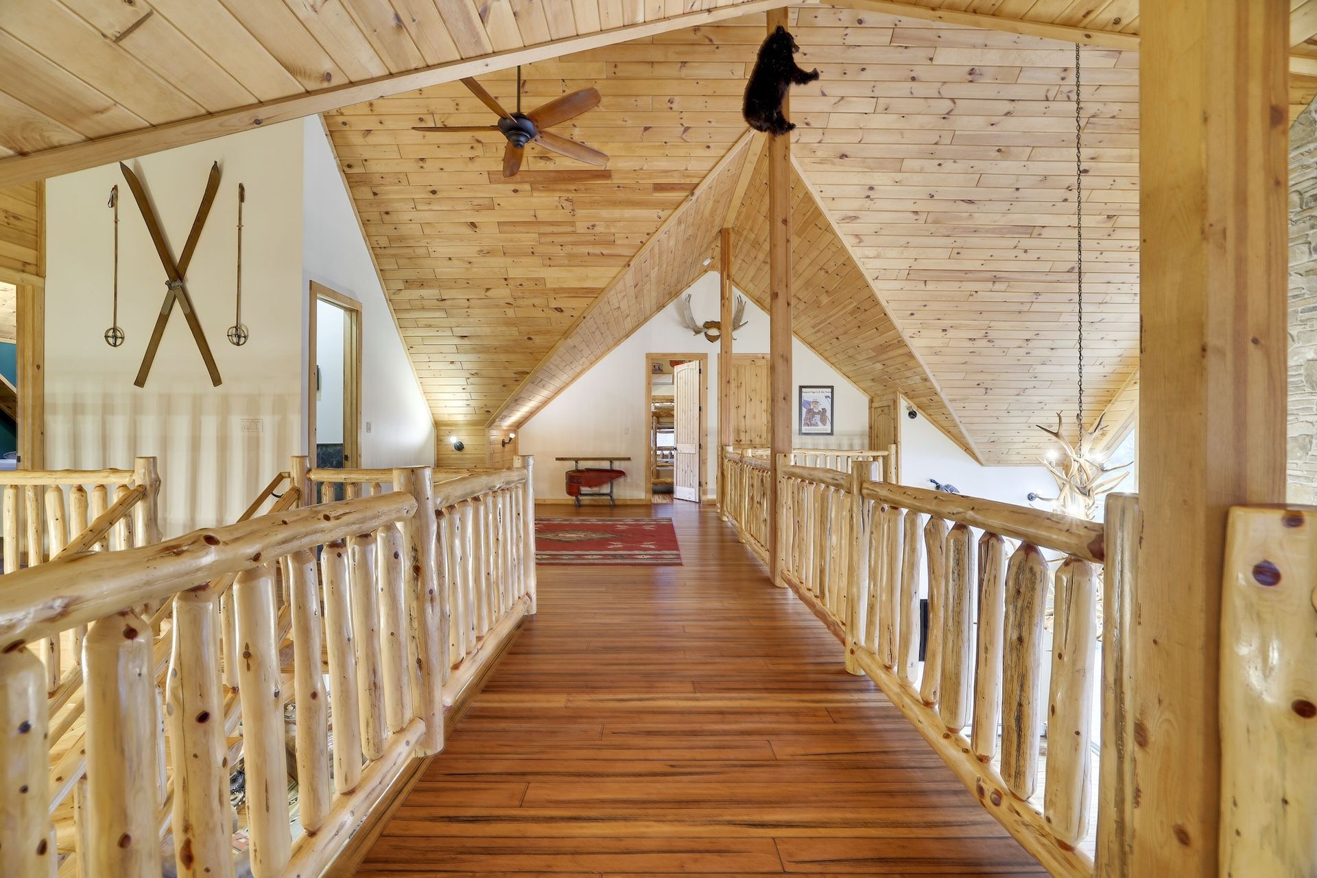 A wooden hallway with a bear hanging from the ceiling