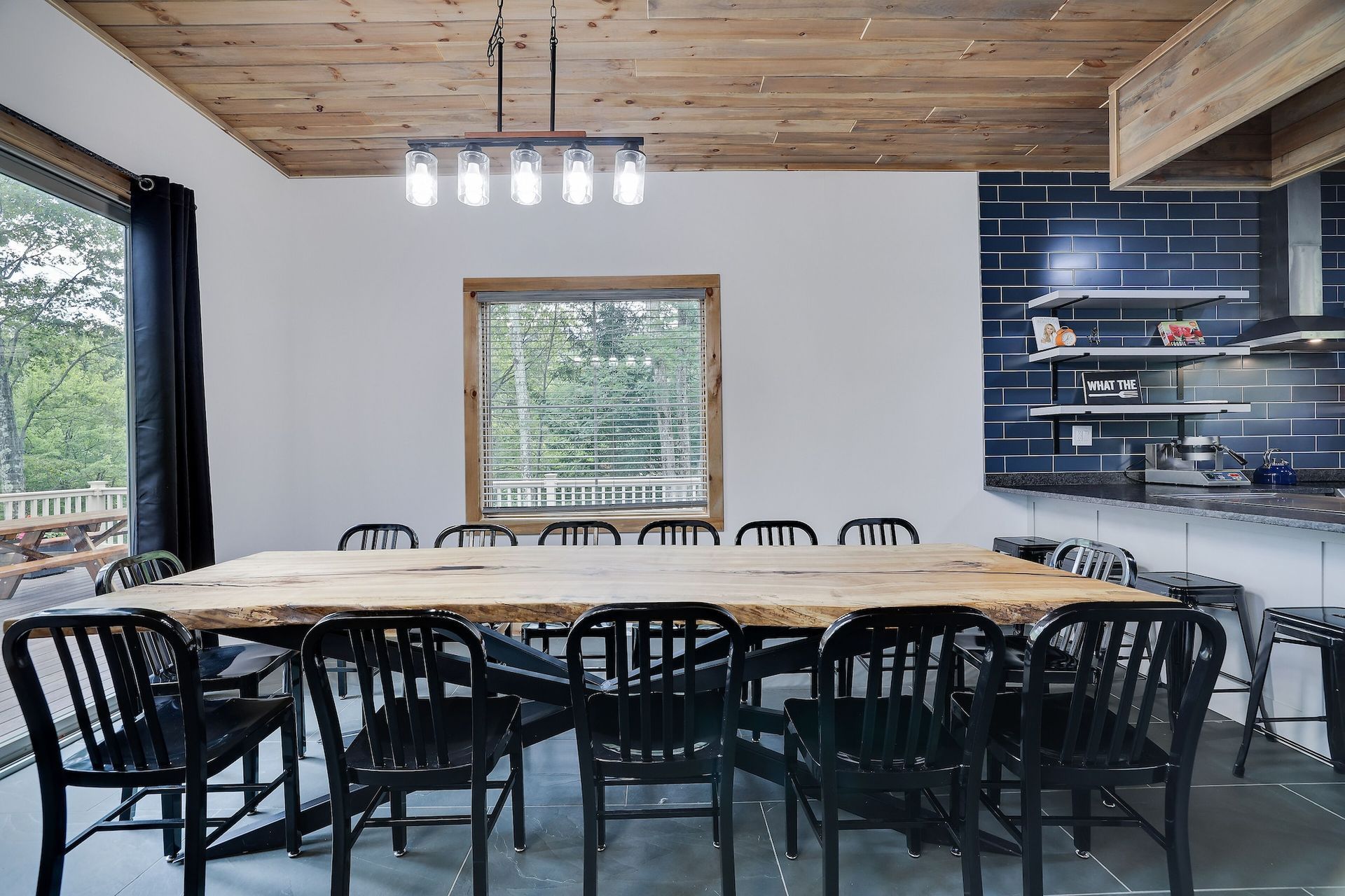 A large dining room with a wooden table and chairs