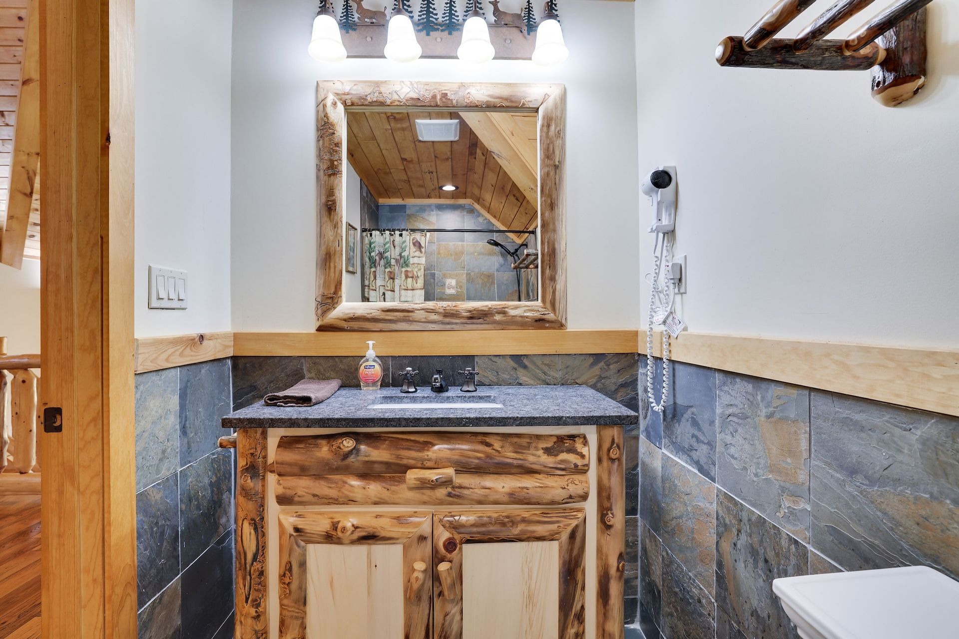 A bathroom with a sink , mirror and toilet.
