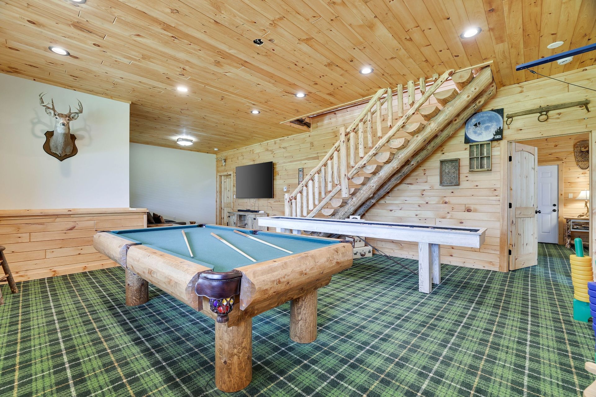 There is a pool table in the middle of the room.