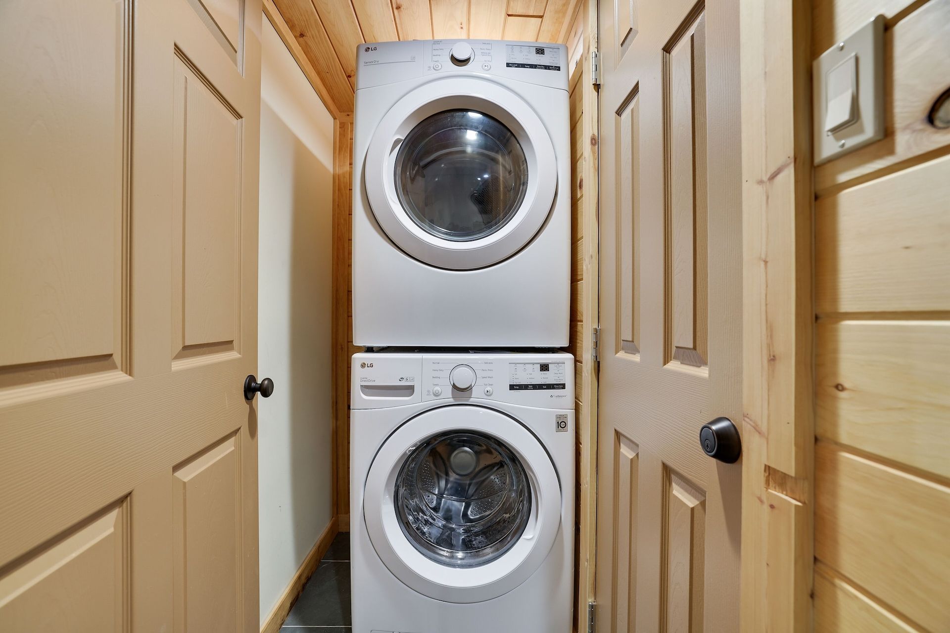 A washer and dryer are stacked on top of each other in a laundry room.