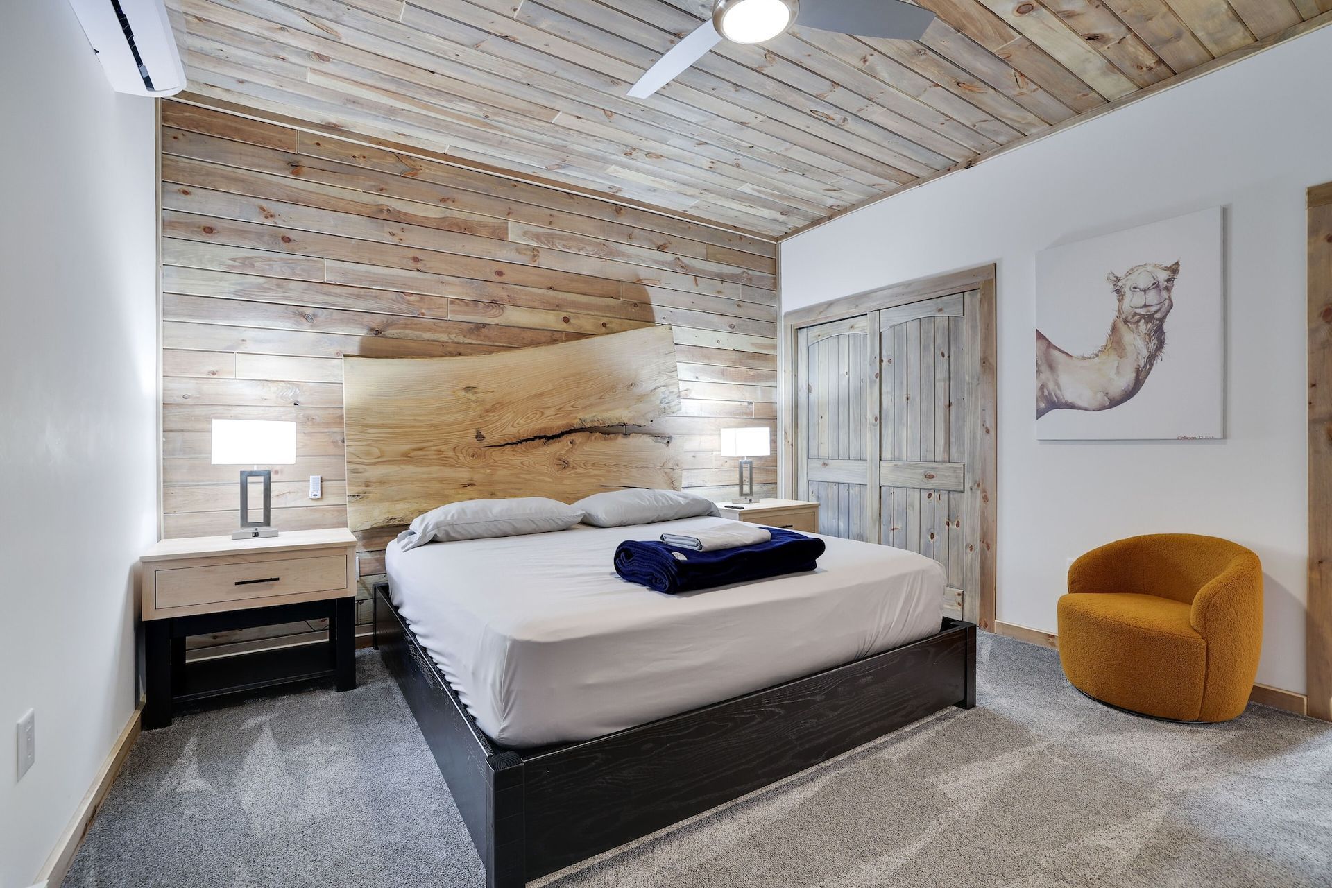 A bedroom with a king size bed and a chair.