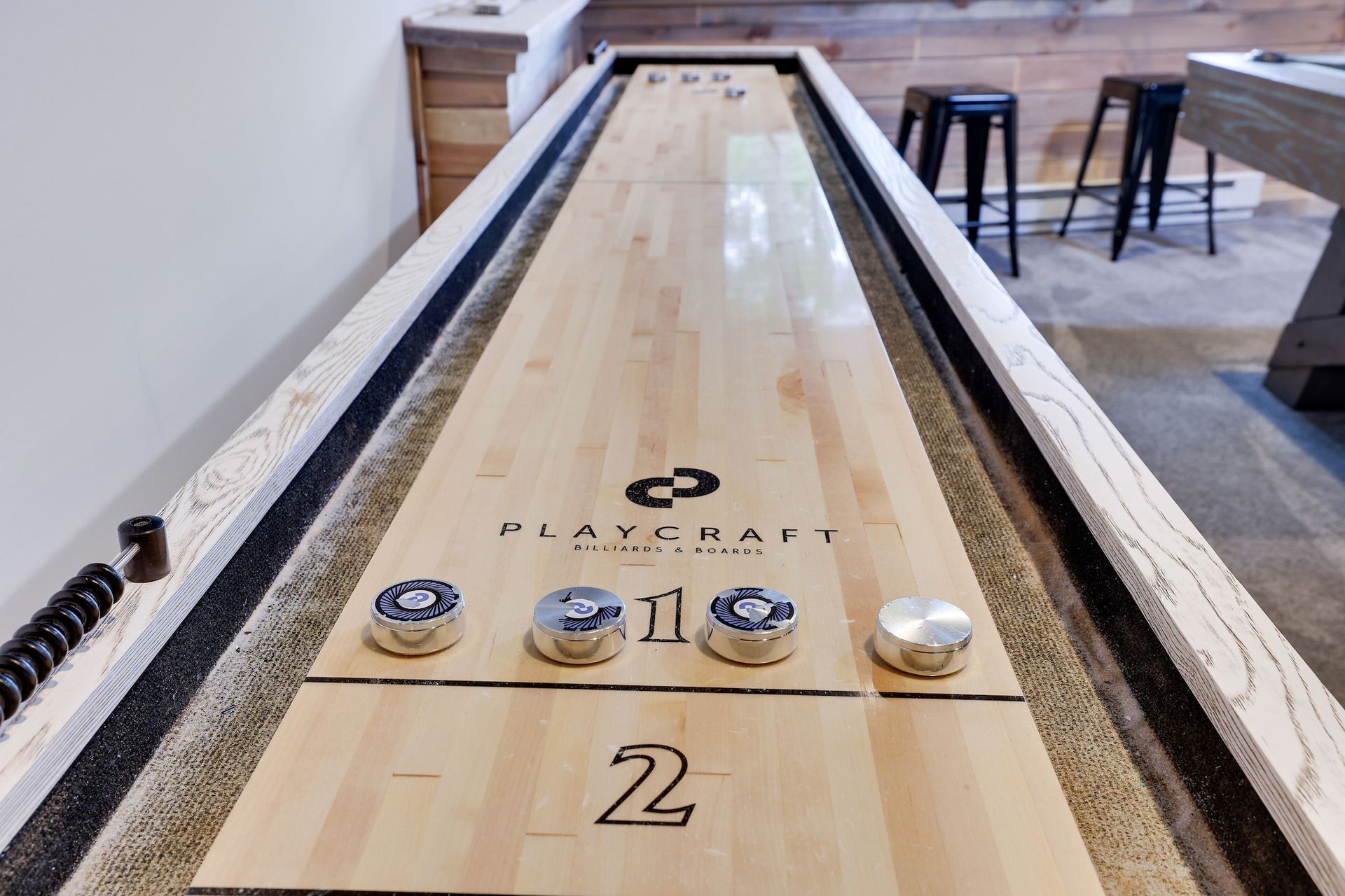 A wooden bowling alley with the number 2 on it