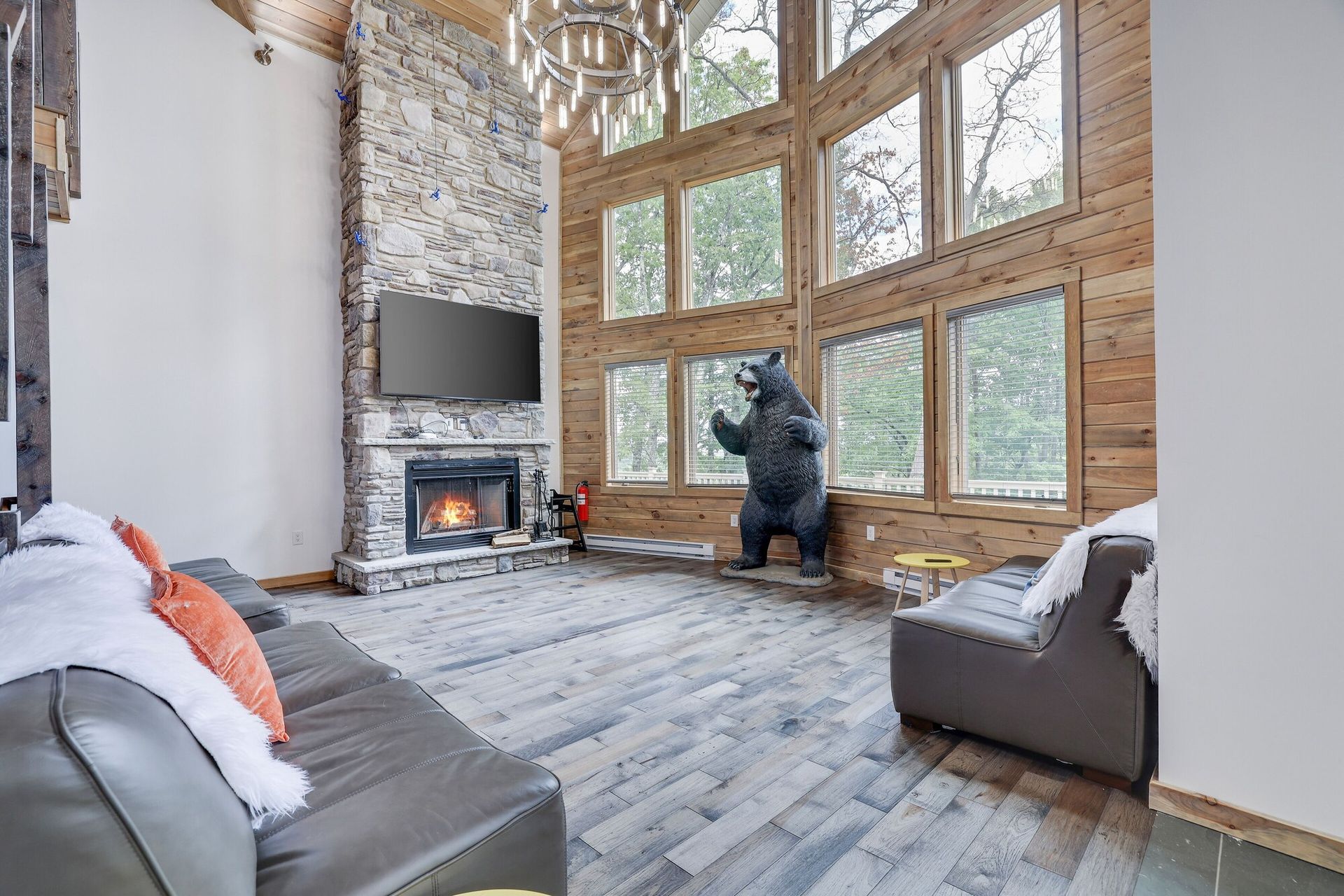 A living room with a bear statue on the wall and a fireplace.