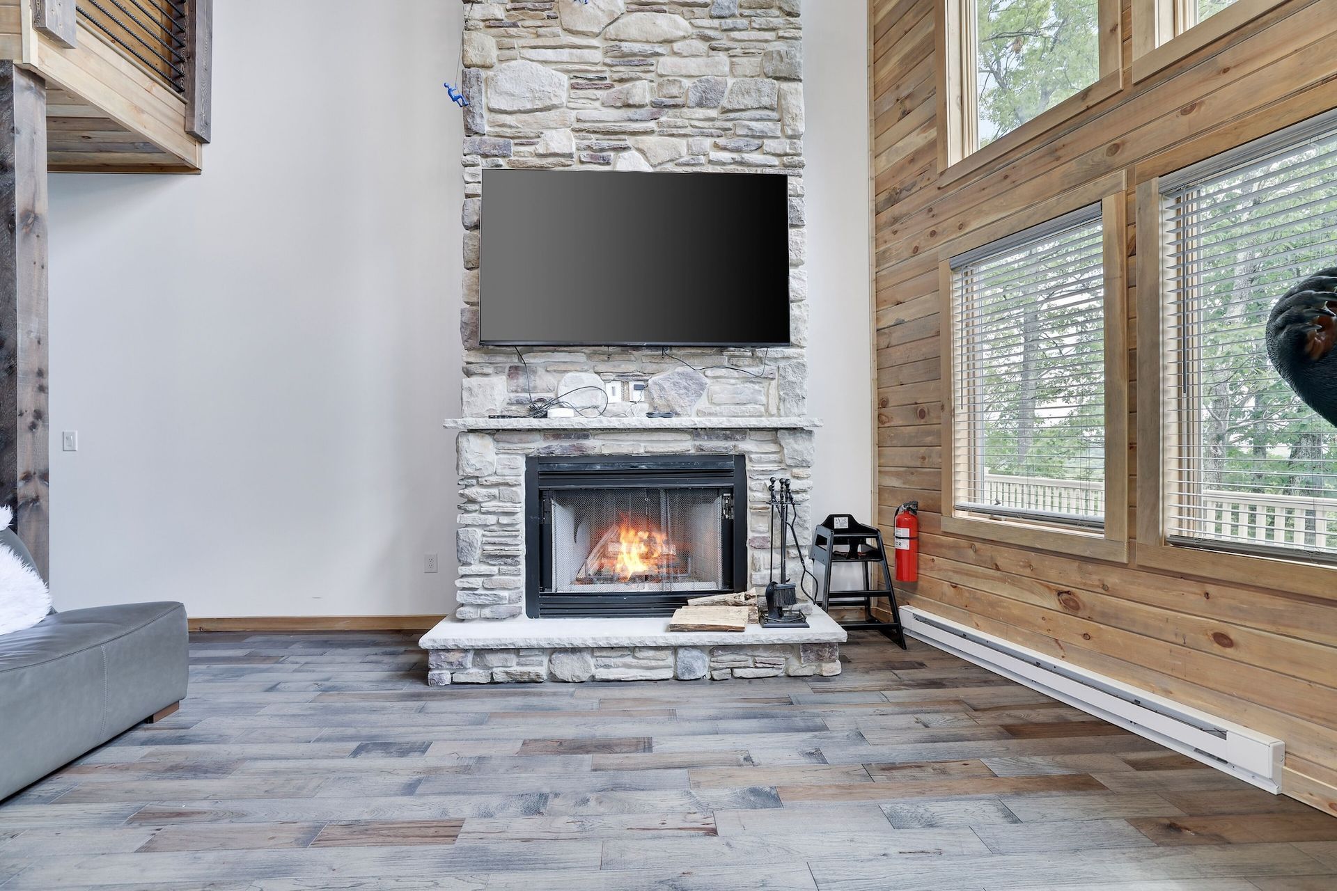 A living room with a fireplace and a flat screen tv.