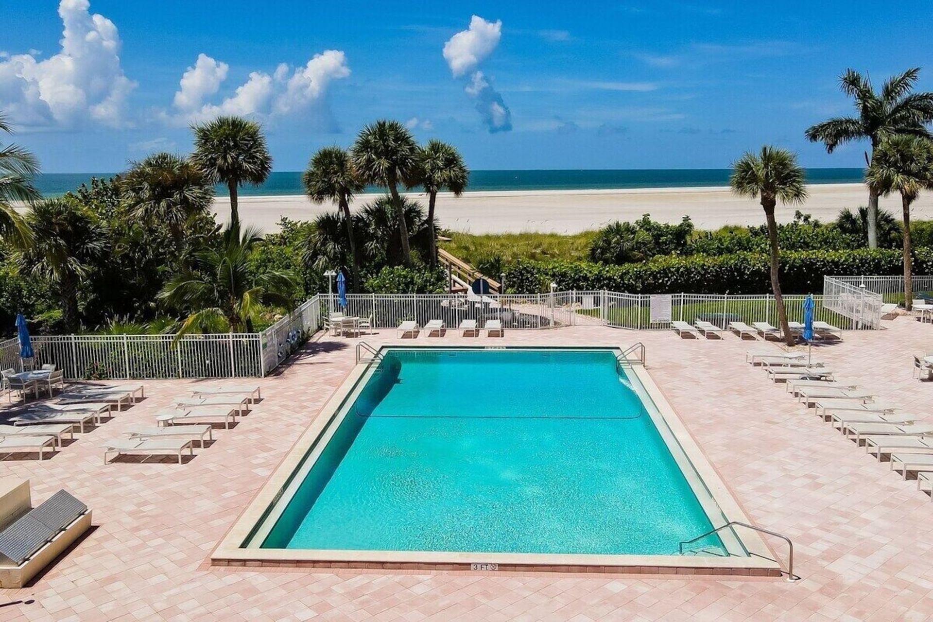 A large swimming pool with a view of the ocean