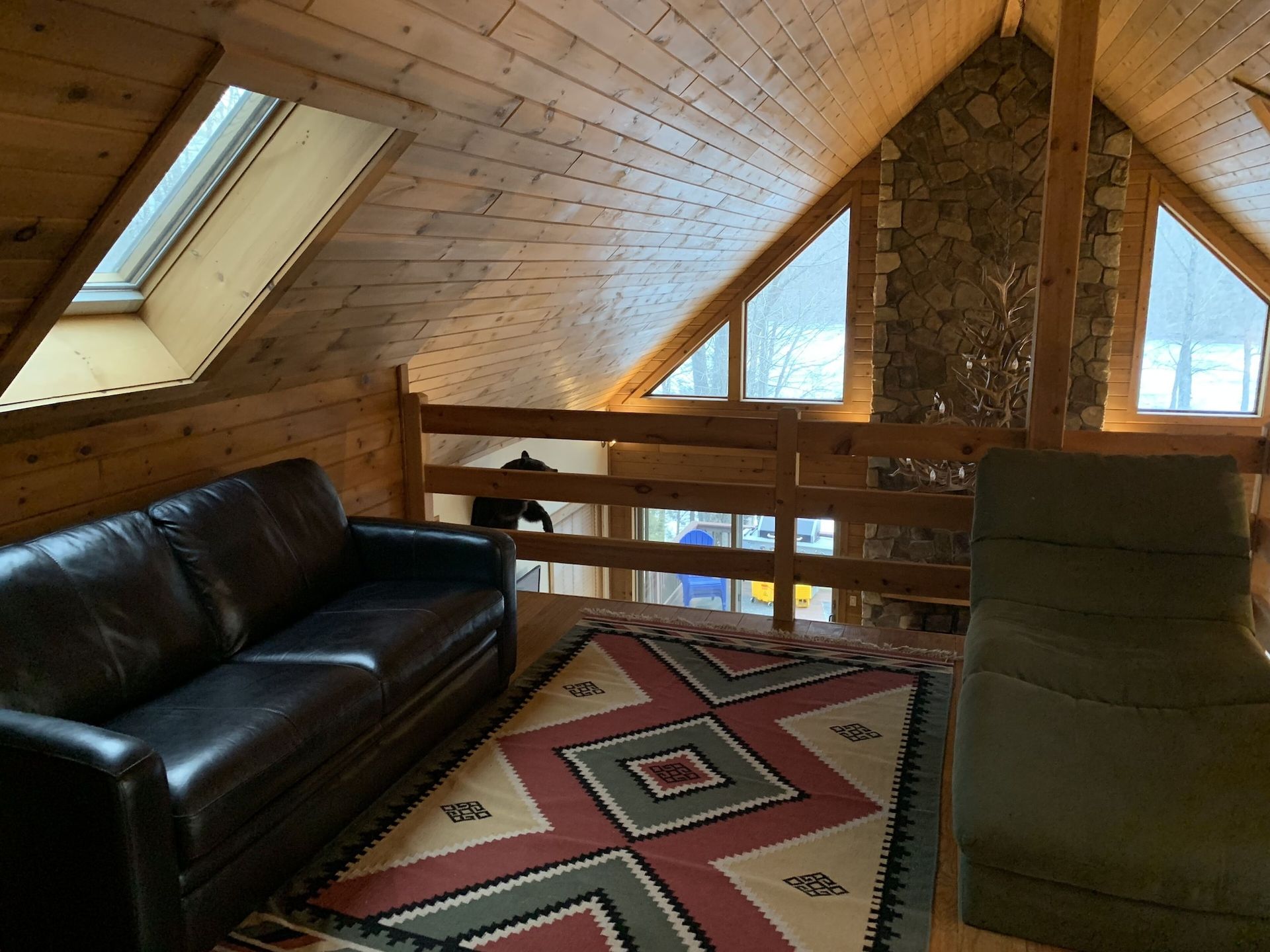 A living room with a couch a chair and a rug