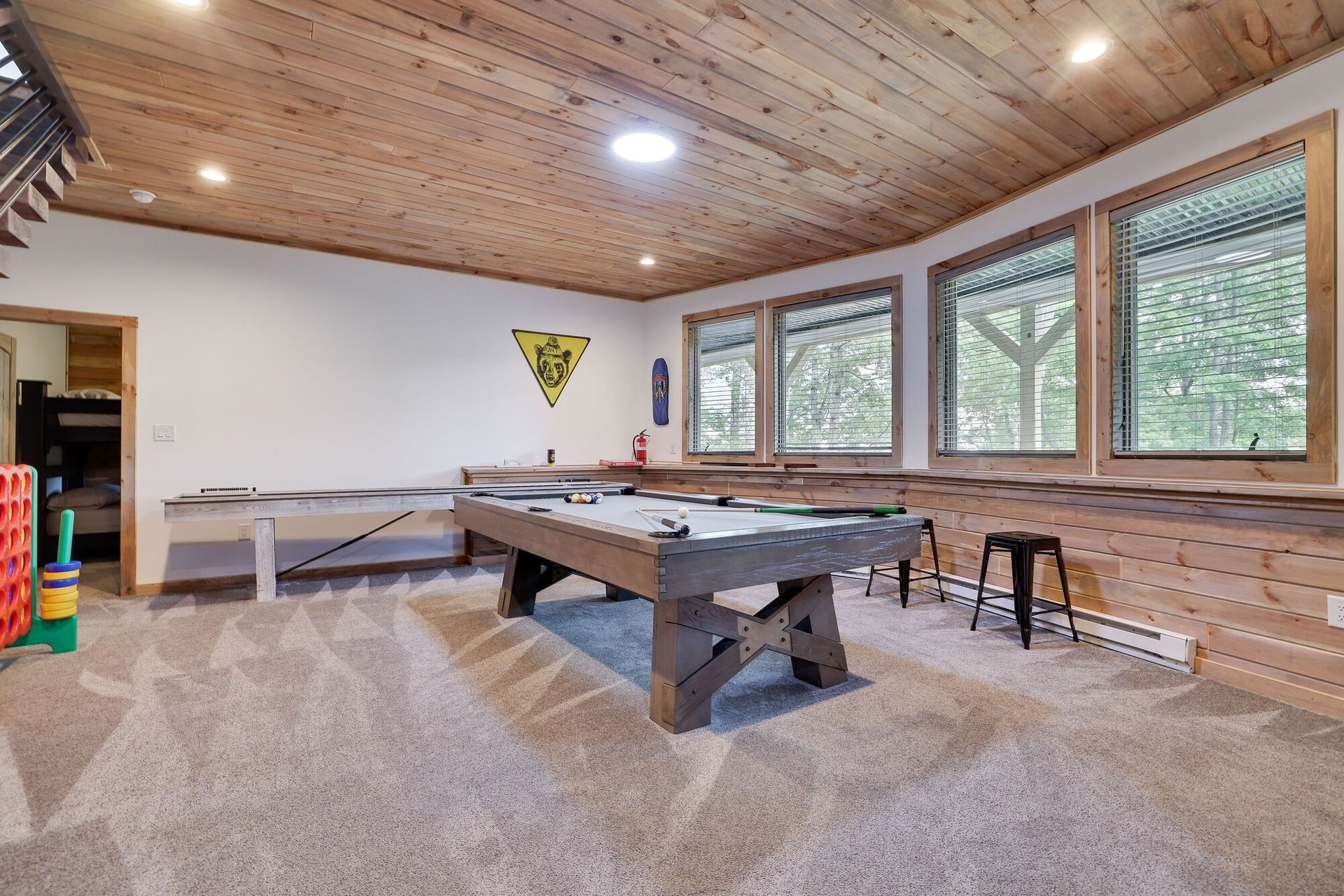 There is a pool table in the middle of the room.