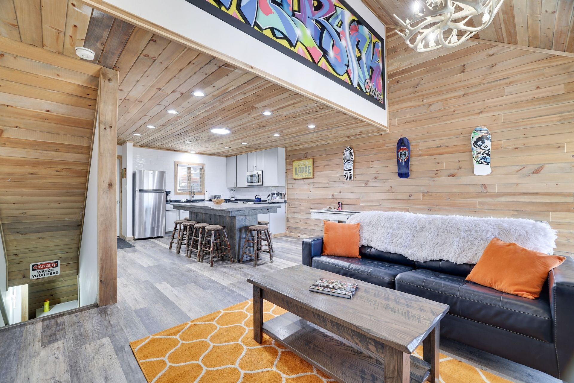 A living room with a shuffleboard table and a couch