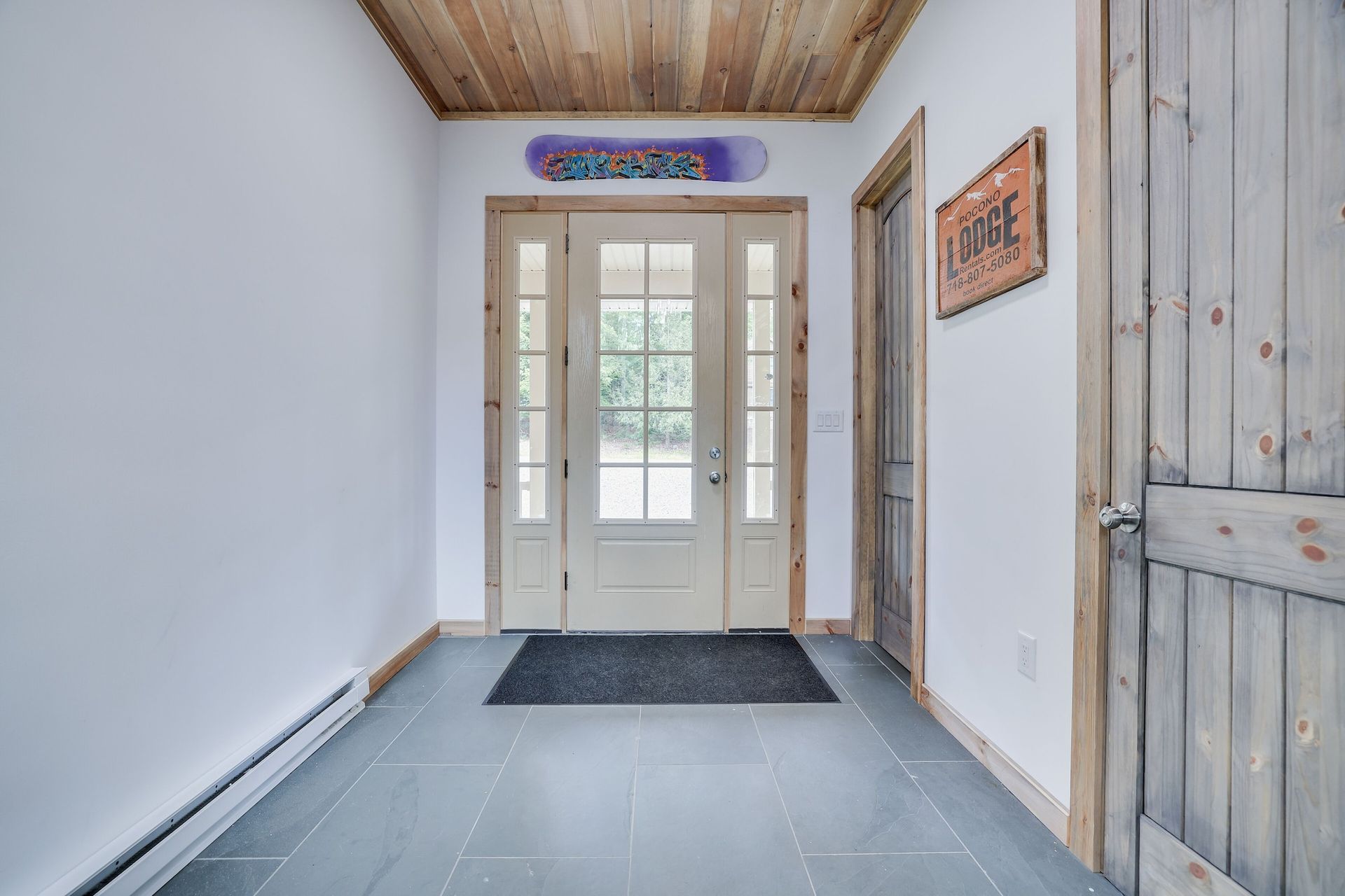 A hallway with a snowboard on the wall above the door