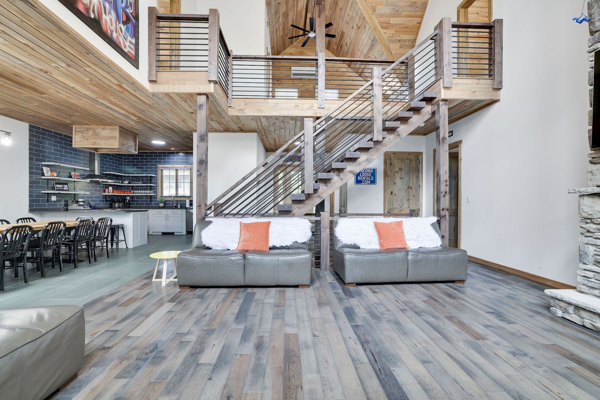 A living room with a staircase leading up to the second floor.