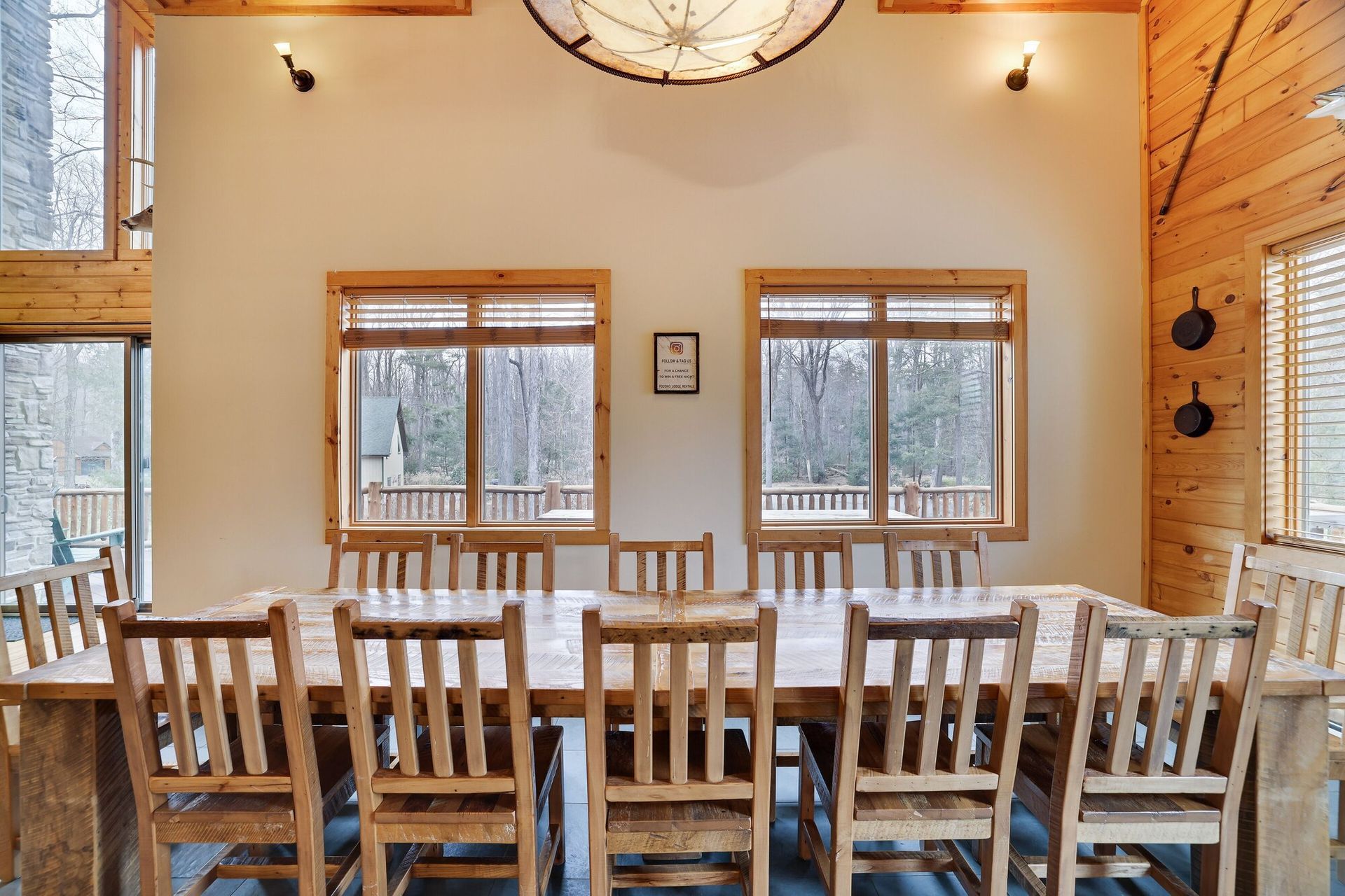A dining room with a long table and chairs
