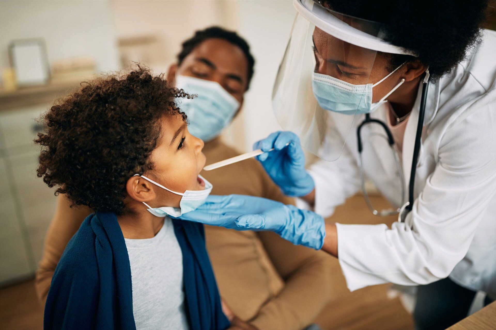 Doctor Examining Boy's Throat — San Pedro, CA — San Pedro Urgent Care