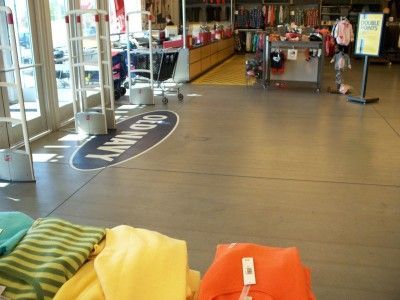 Retail store entrance with display tables, carts, and colorful beanbags in the foreground