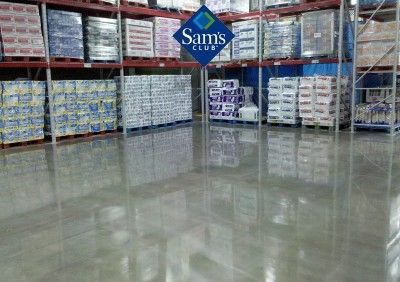 Sam’s Club warehouse aisle with stacked pallets of bulk goods and a polished concrete floor