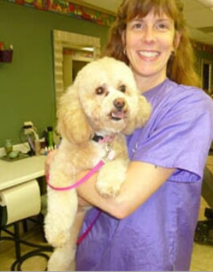 Dog Grooming — Karen Holding a Dog in Lansing, MI