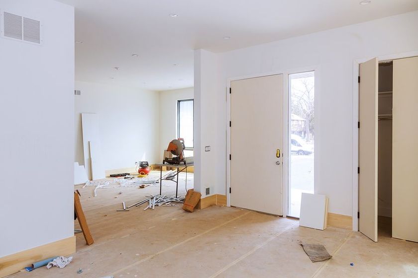 An empty room with a wooden floor and white doors