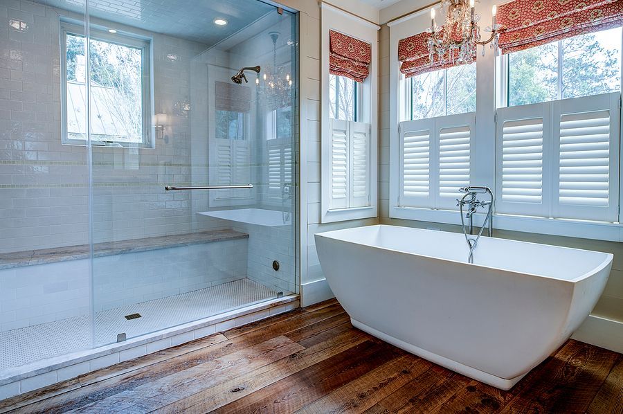 A bathroom with a bathtub and a walk in shower