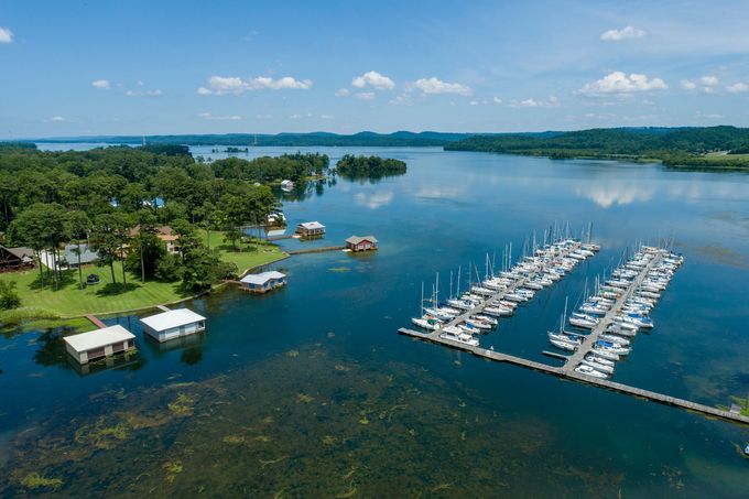 An aerial view of a lake with boats docked in it