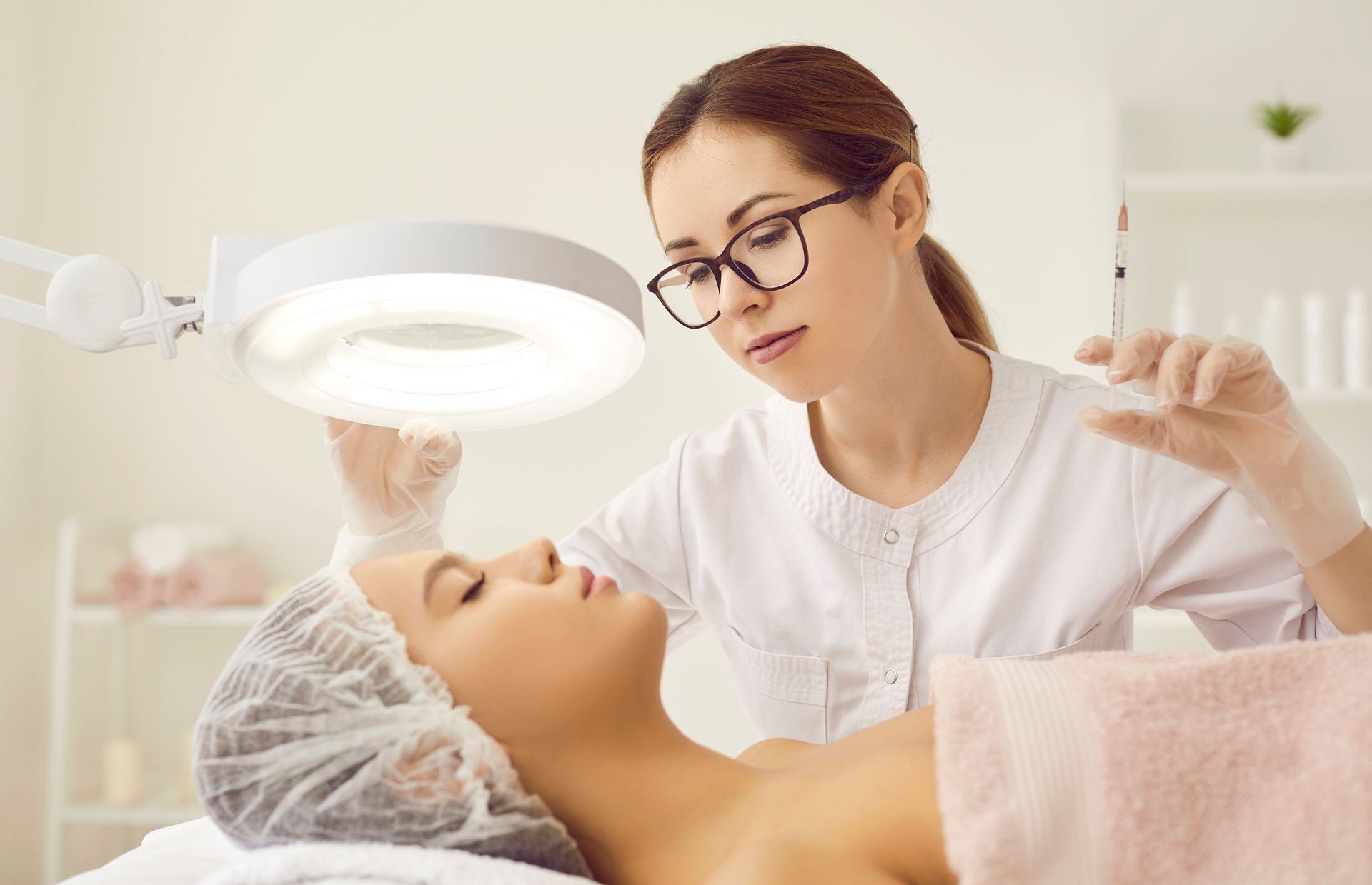 A woman is getting a facial treatment at a beauty salon.