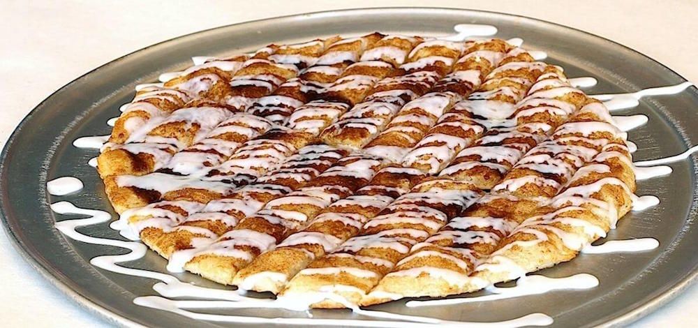 Cinnamon dessert pizza with icing drizzled on top