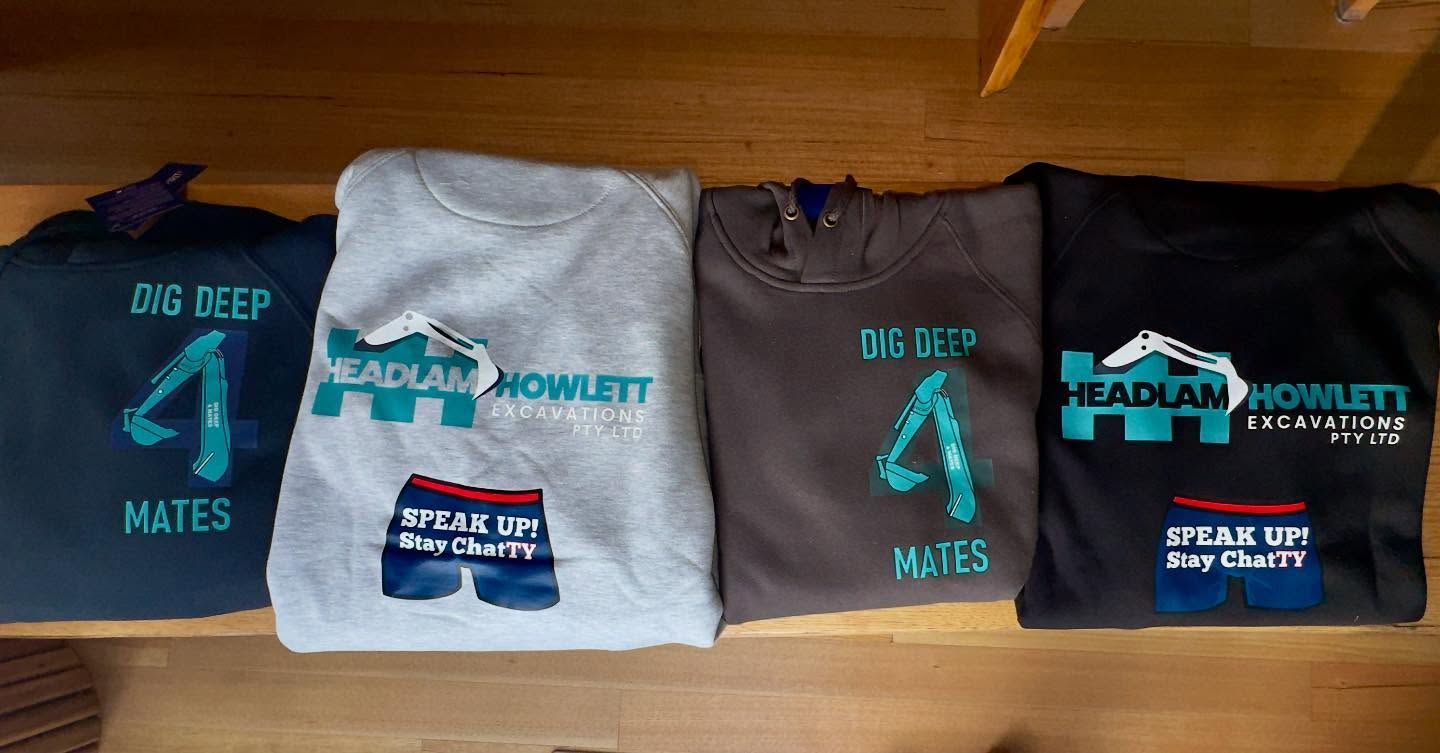 Four sweatshirts with printed designs. Designs include text, 