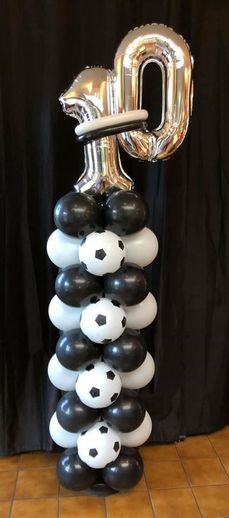 A stack of black and white balloons with a number 10 on top.