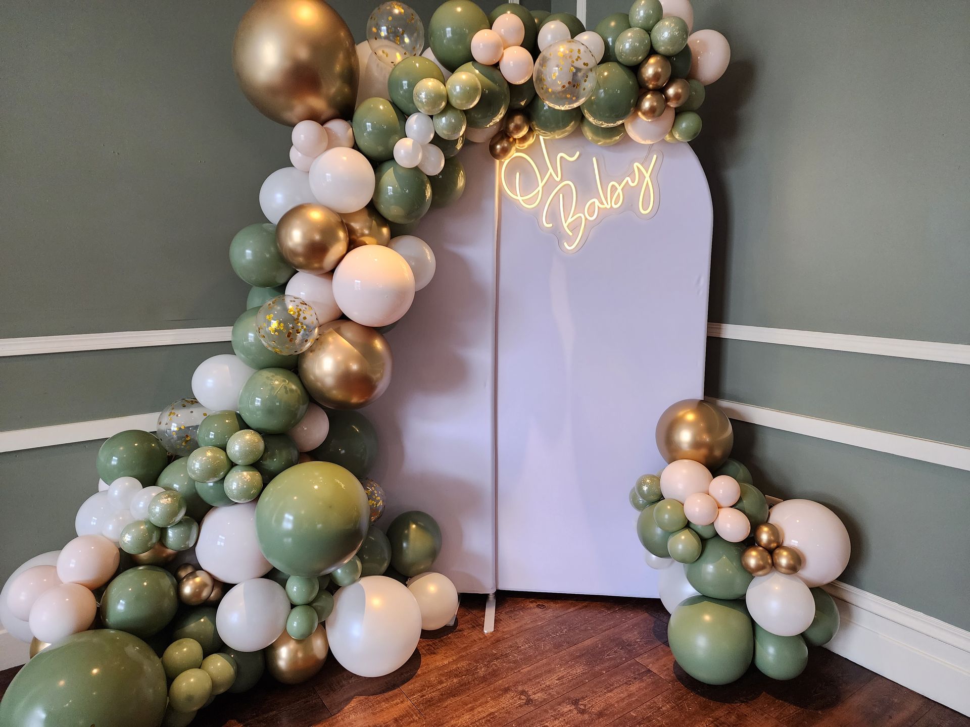 A room filled with balloons and a sign that says happy baby.