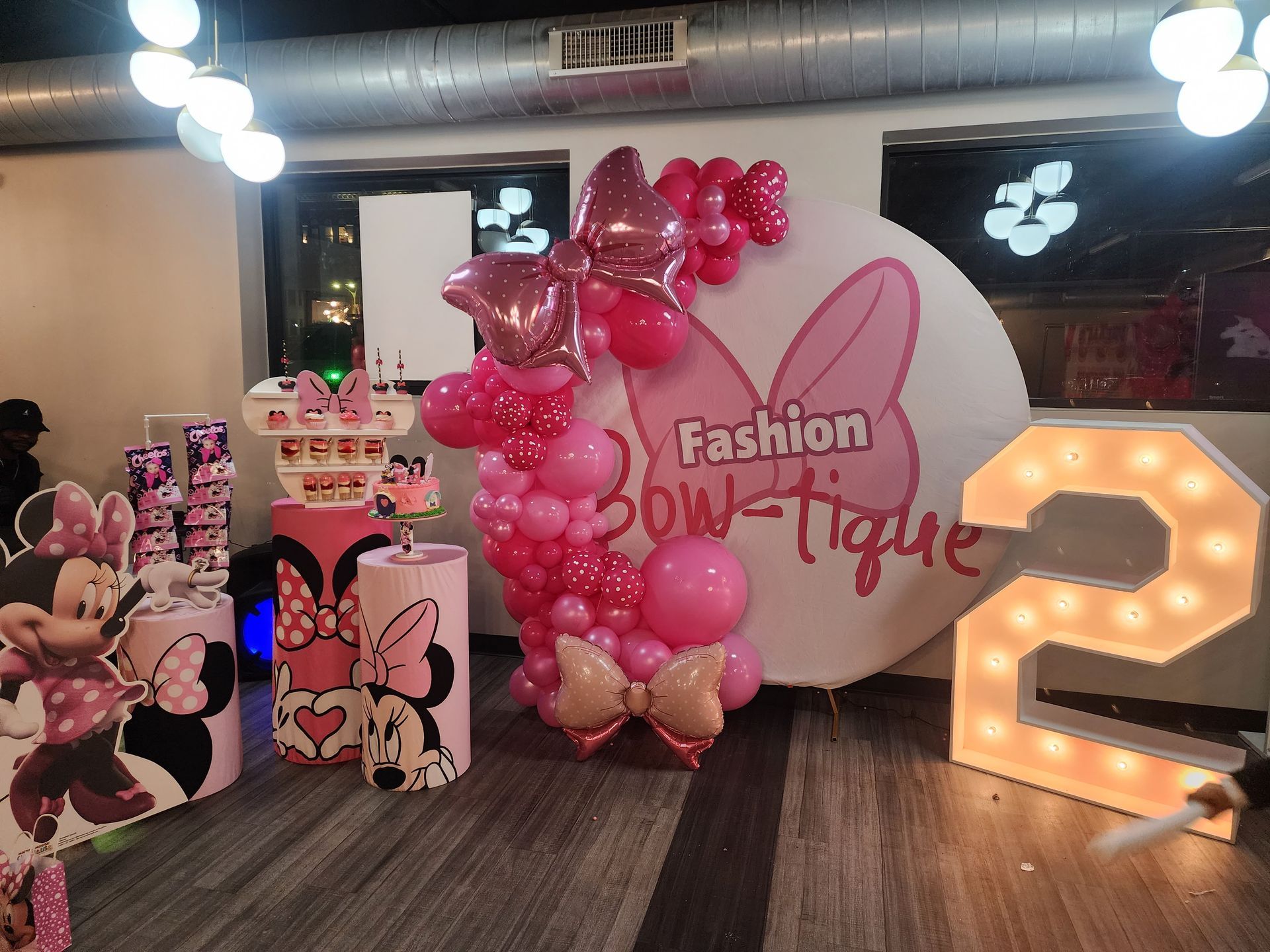 A room with balloons and a sign that says fashion boutique