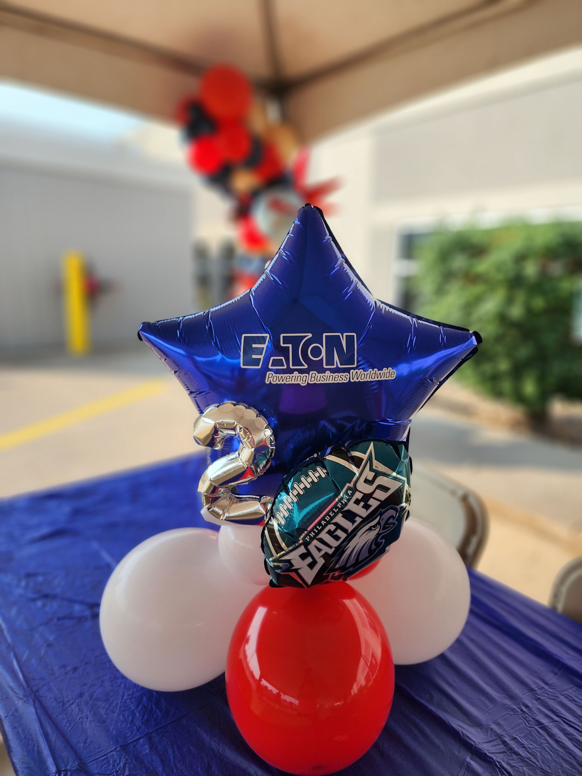 A blue star shaped balloon with the number 2 on it