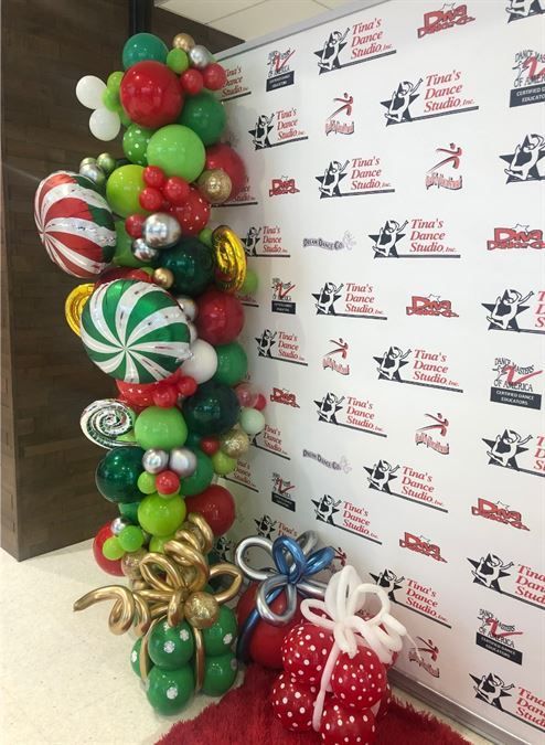 A wall with a bunch of balloons on it