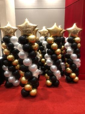 A bunch of balloons are sitting on top of each other on a red carpet.