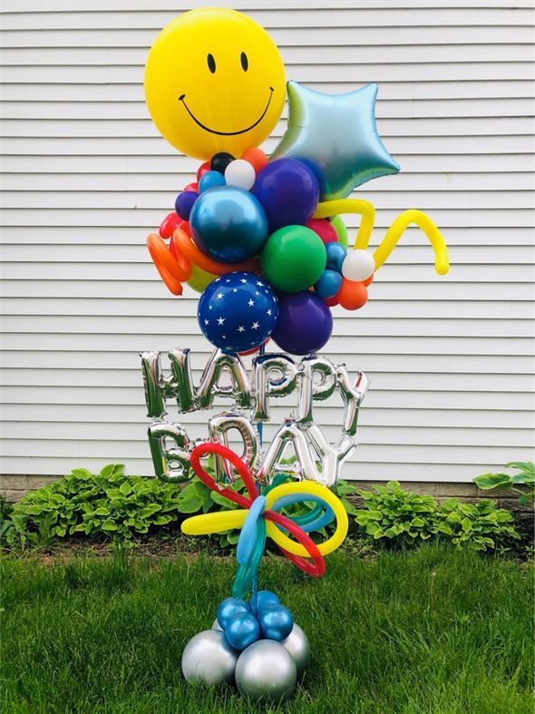 A bunch of balloons with a smiley face and the words happy birthday