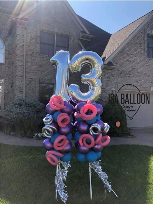 A bunch of balloons with the number 13 on them