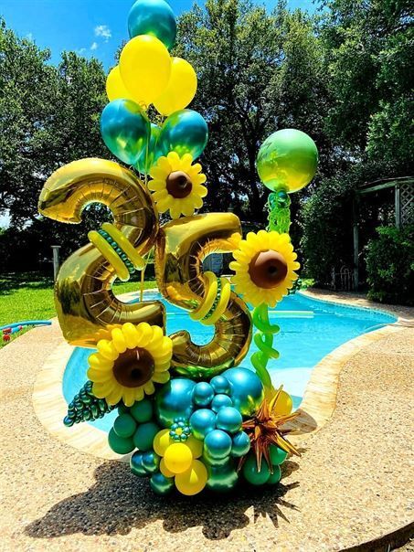 A bunch of balloons with the number 25 on them