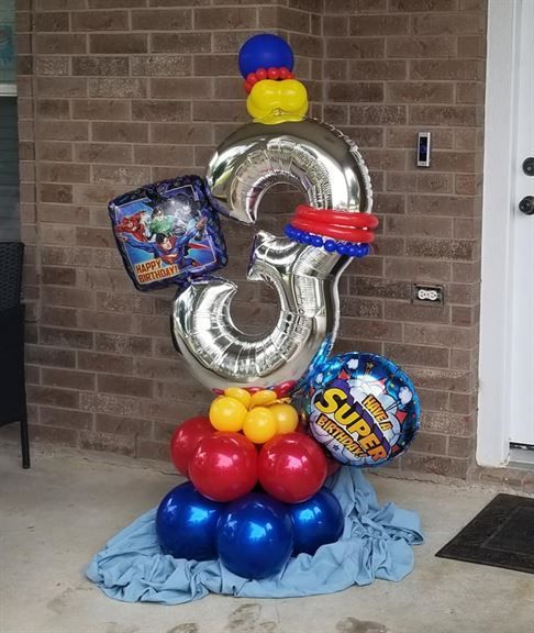 A bunch of balloons with the number 3 on top
