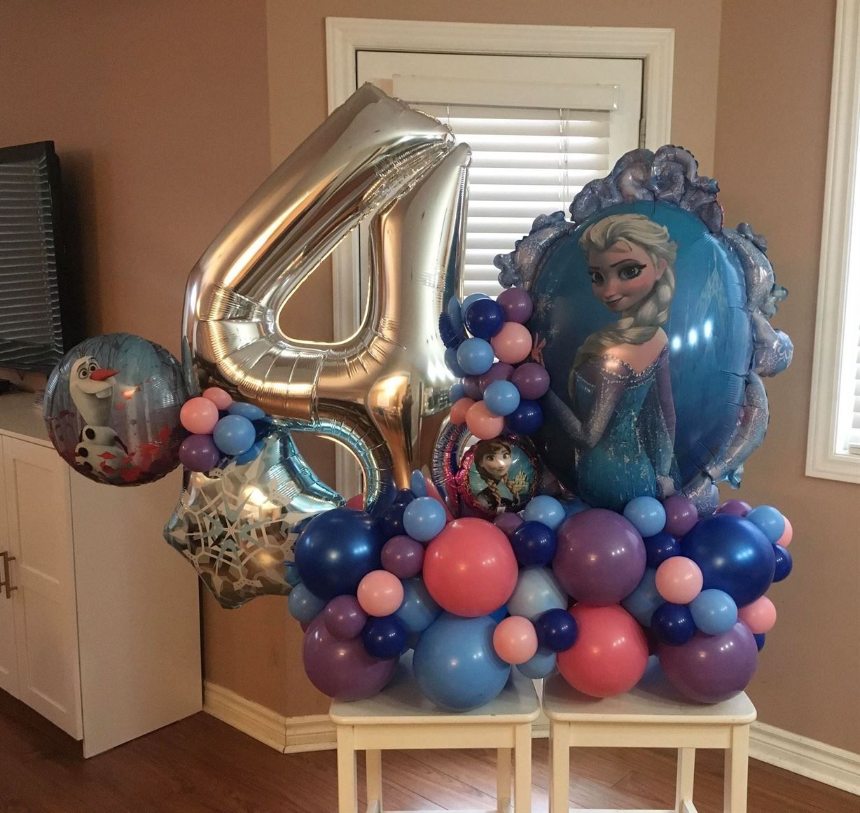 A bunch of balloons including one that has the number 4 on it