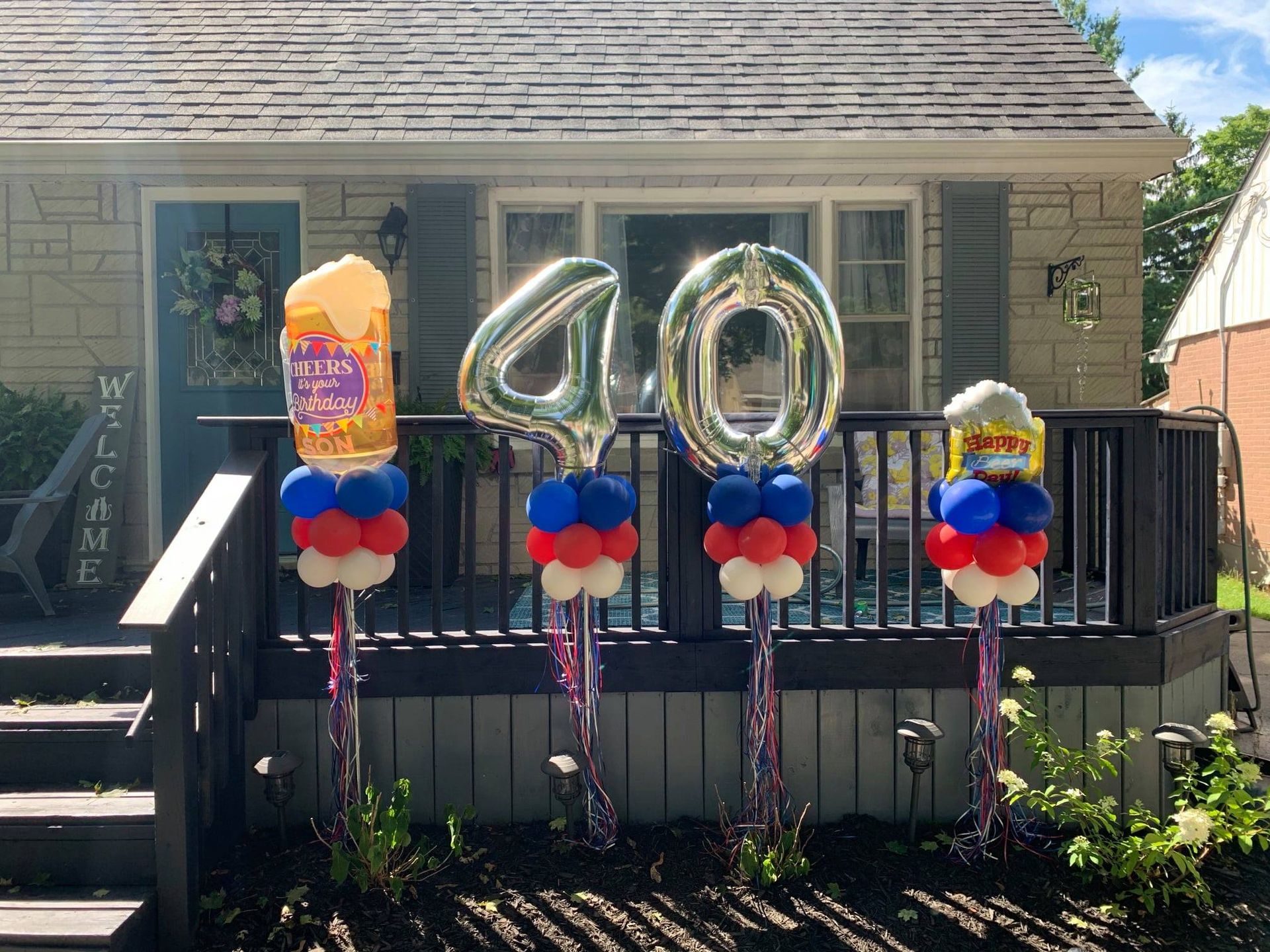 A house decorated with balloons for a 40th birthday.