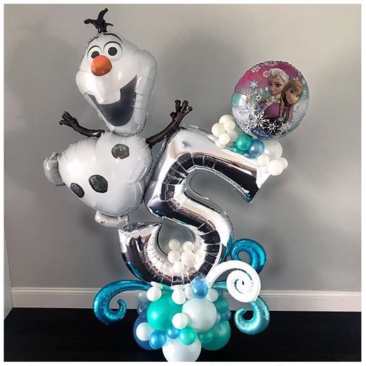 A bunch of balloons are sitting on top of each other on a table.