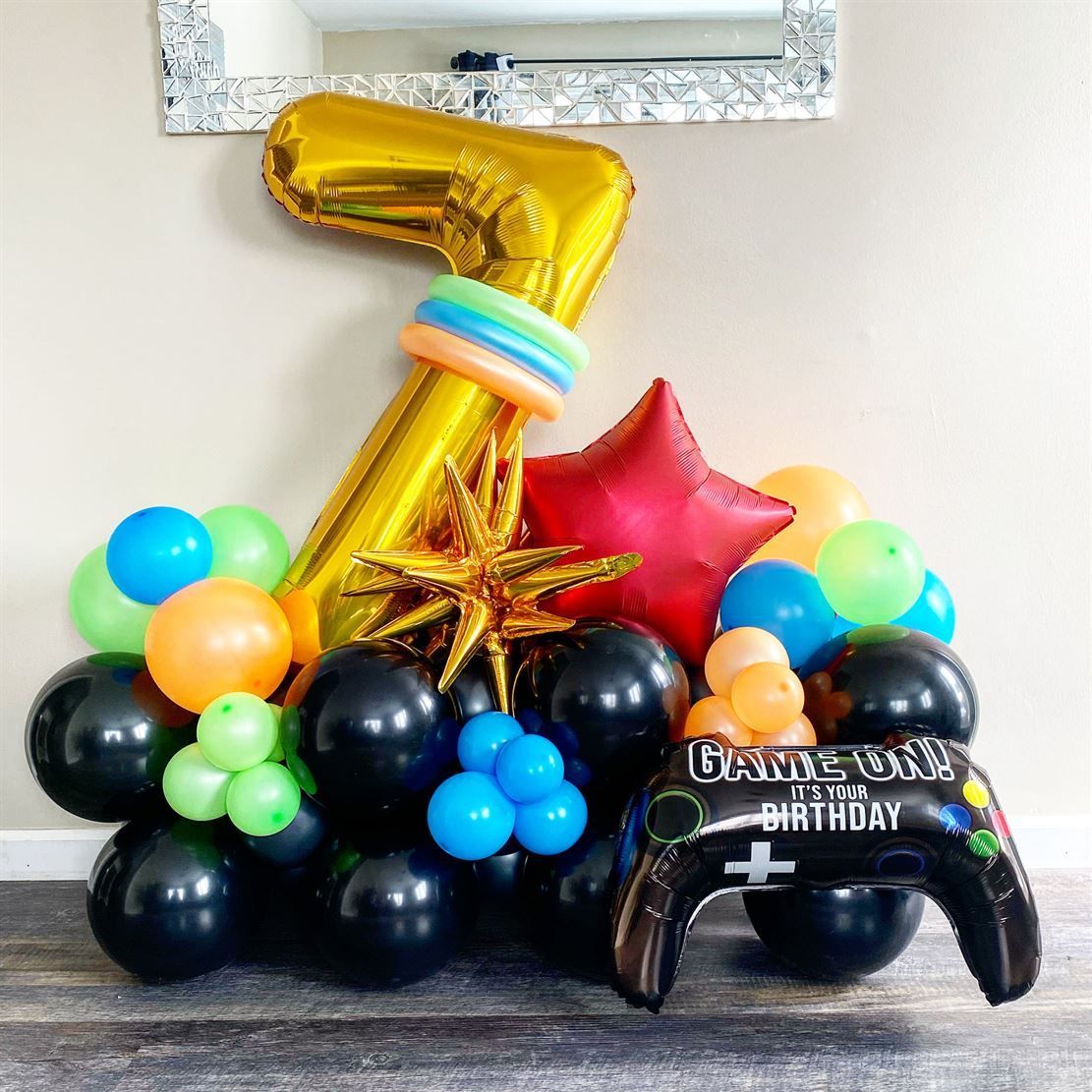 A bunch of balloons are sitting on top of each other on a table.