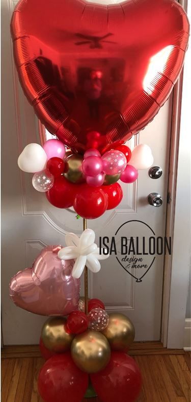 A bunch of balloons are sitting on top of each other in front of a door.