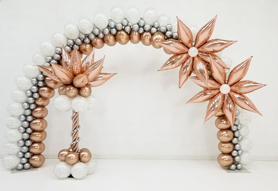 A balloon arch with flowers made of balloons on a white background.