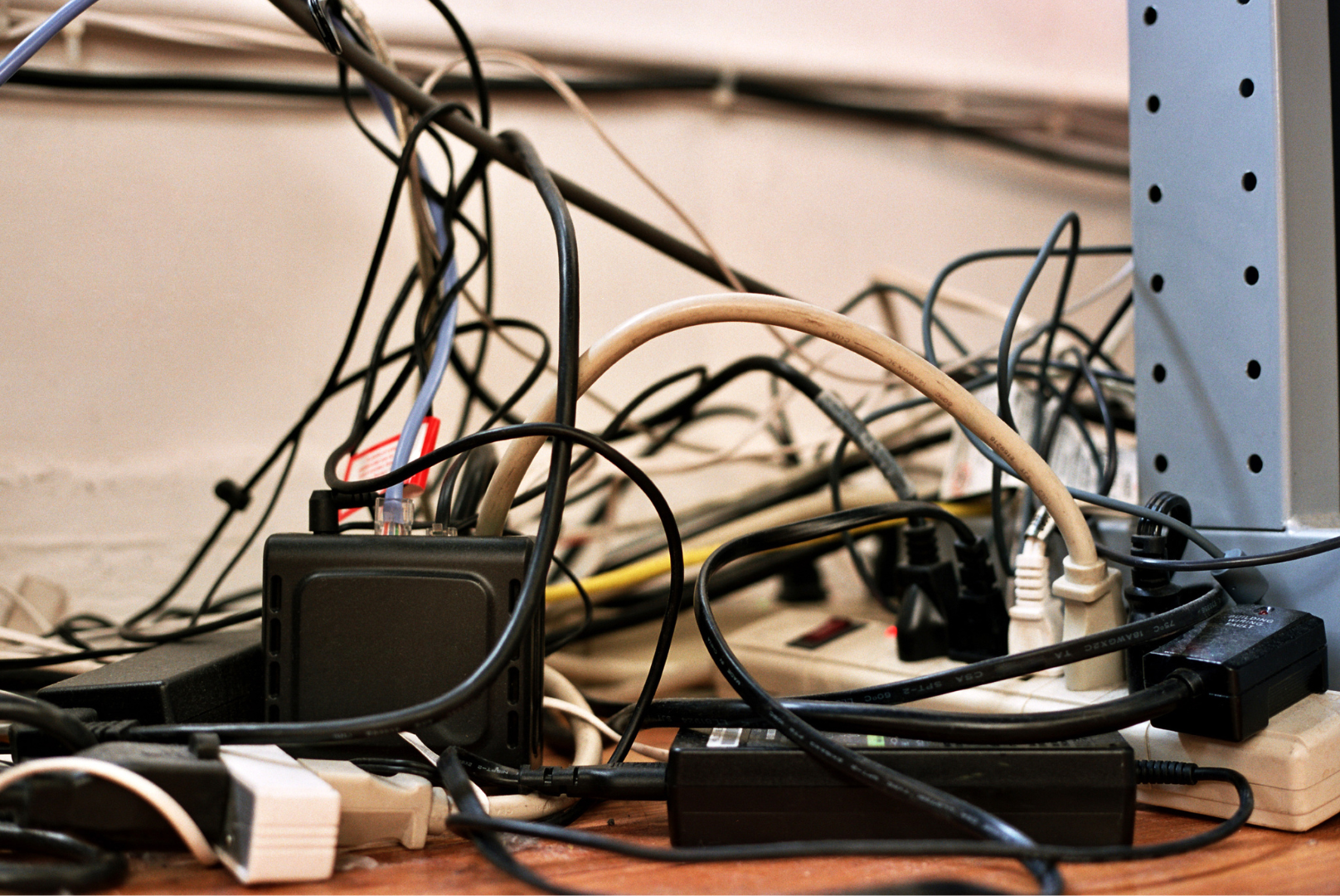 A bunch of wires are plugged into a power strip