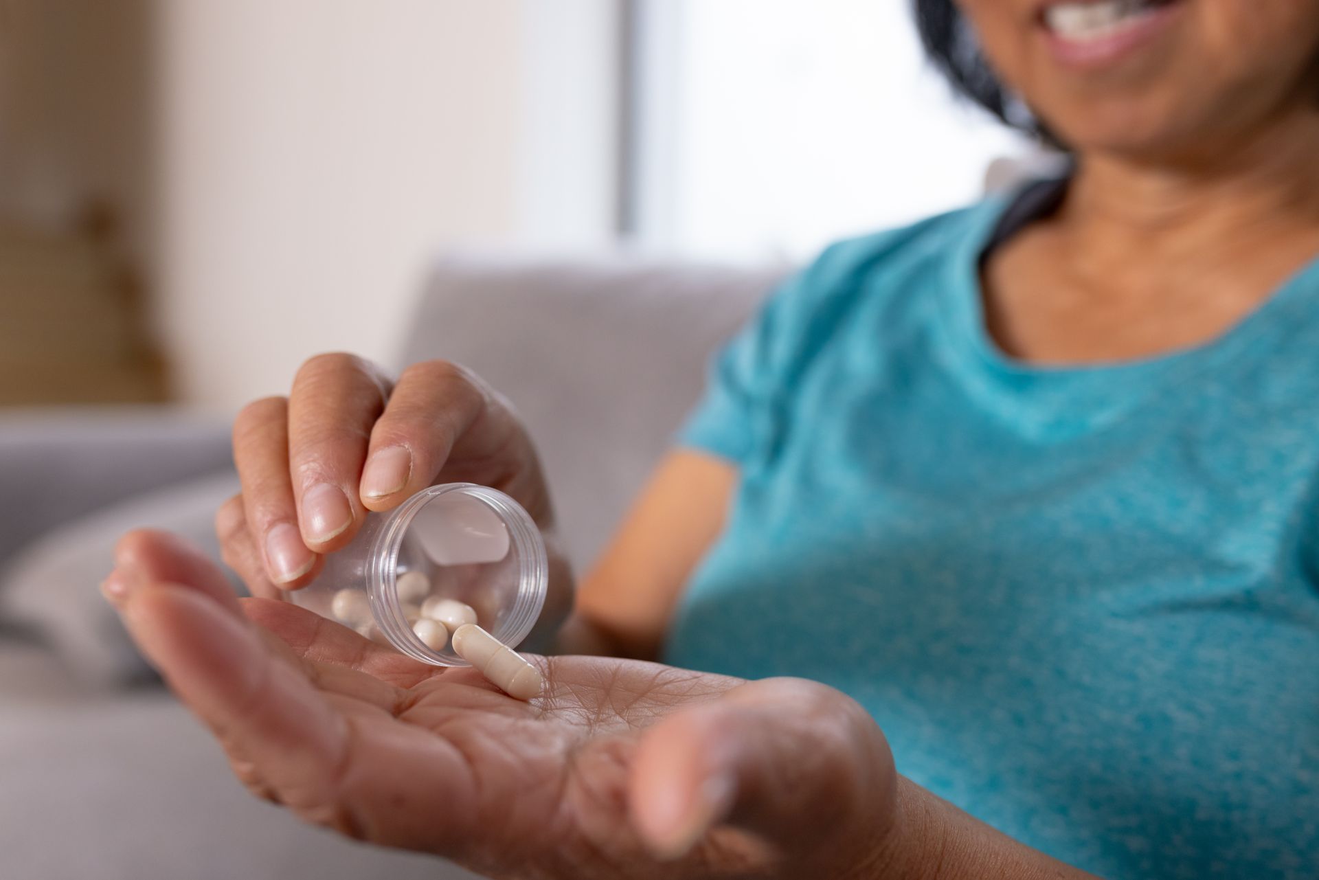 A woman is taking some pills.