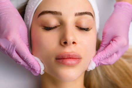 A woman is getting a botox facial treatment at Higley Dental Care