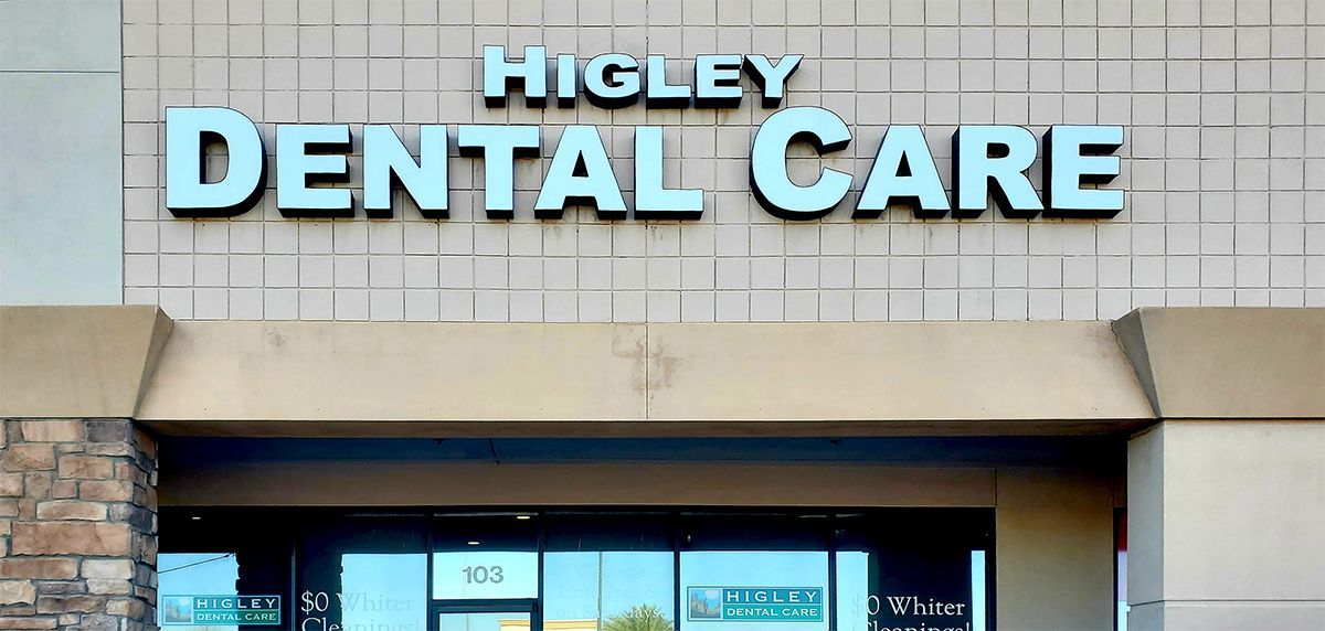 The front of a dental care clinic with a sign that says higley dental care.
